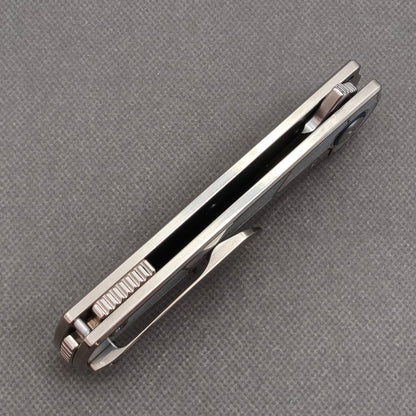 VORIXN KB063 closed side construction view showing pocket clip, spacer, and titanium handle layers.
