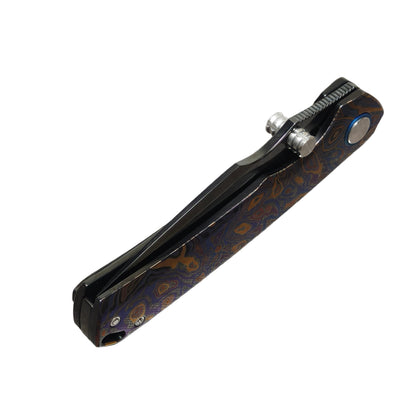 VORIXN Topograph Zirconium VG10 folding knife closed front view showing detailed blade pattern, zirconium handle texture, and premium craftsmanship