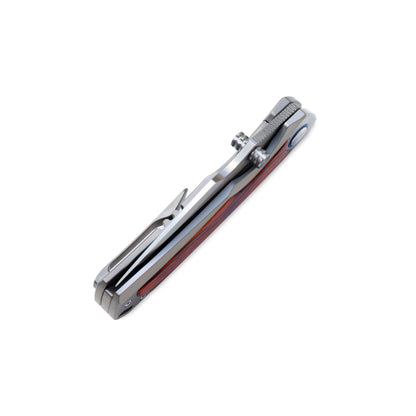 VORIXN Ironwood Crest folding knife closed at an angle, blade spine facing upward with refined titanium ironwood handle