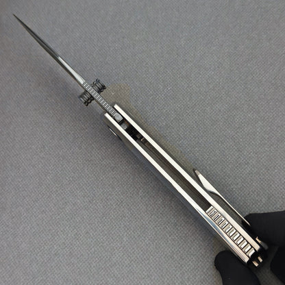 Spine view of the open VORIXN Ocean Mirage KB093 showing blade jimping, dual thumb studs and handle construction.