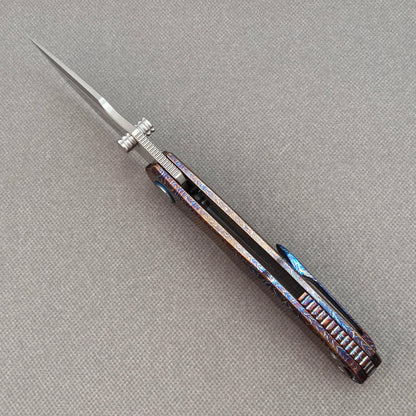 VORIXN KB051 open spine-side structure showing blade alignment and hand-flamed titanium handle thickness.