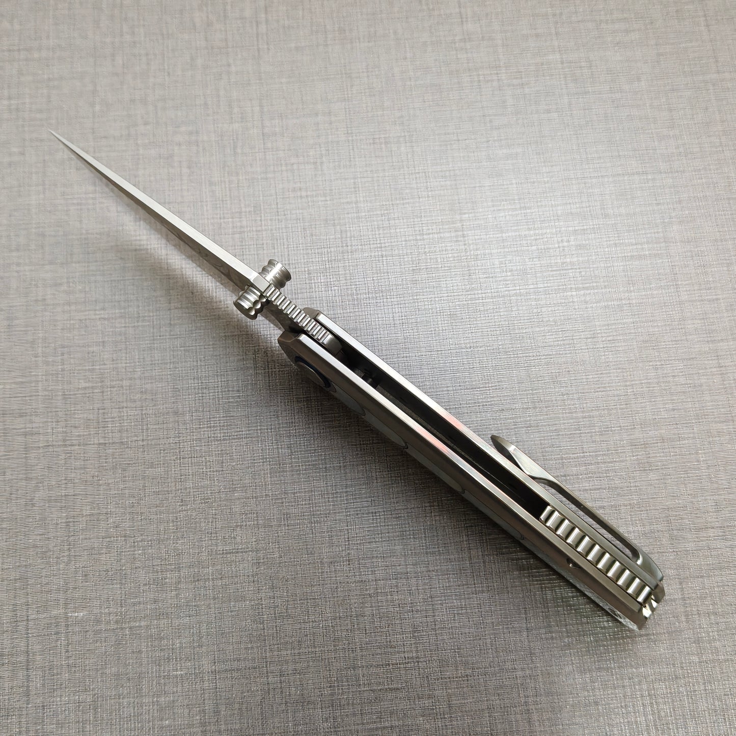 VORIXN Ocean Mirage folding knife open, front view from the spine showing blade alignment and handle balance