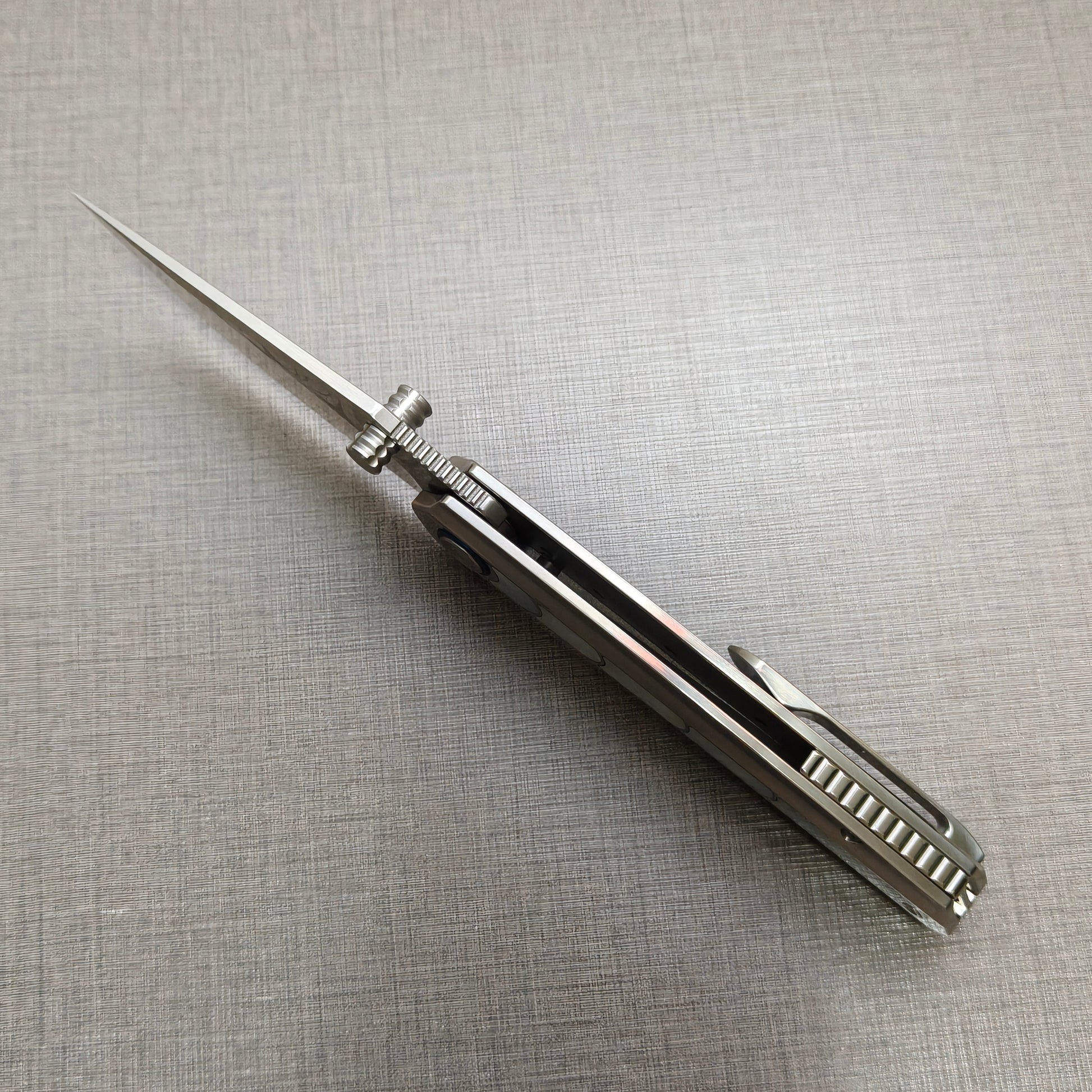 VORIXN Ocean Mirage folding knife open, front view from the spine showing blade alignment and handle balance