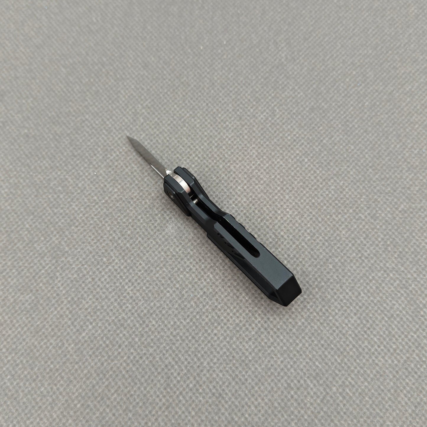 VORIXN NA001 Super Tiny Folding Knife – partially open view showing flipper and pivot mechanism