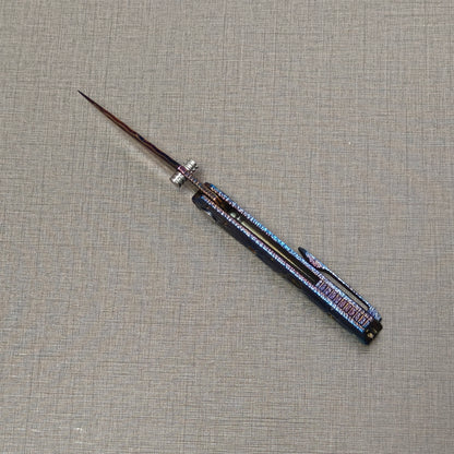 Impact Origin folding knife open viewed from spine, showing blade thickness and frame lock design