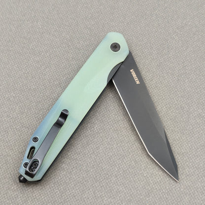 VORIXN KM005 partially open folding knife showing flipper, pivot, and carbon fiber handle profile.
