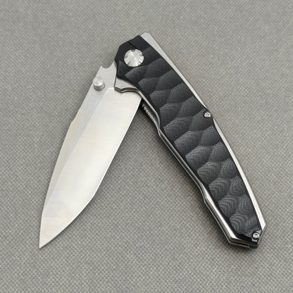 VORIXN KA009 partially open EDC folding knife showing flipper, thumb stud, pivot, and handle profile.