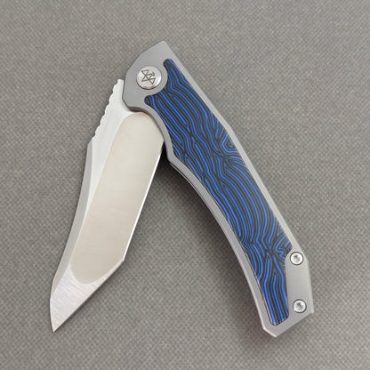 VORIXN Carbon Crest KB003 Folding Knife – partially open EDC view showing flipper, thumb stud, pivot, and Titanium & G10 handle profile