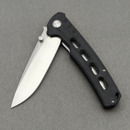 VORIXN KA001 partially open pocket knife showing flipper, thumb stud, pivot, and G10 handle profile.