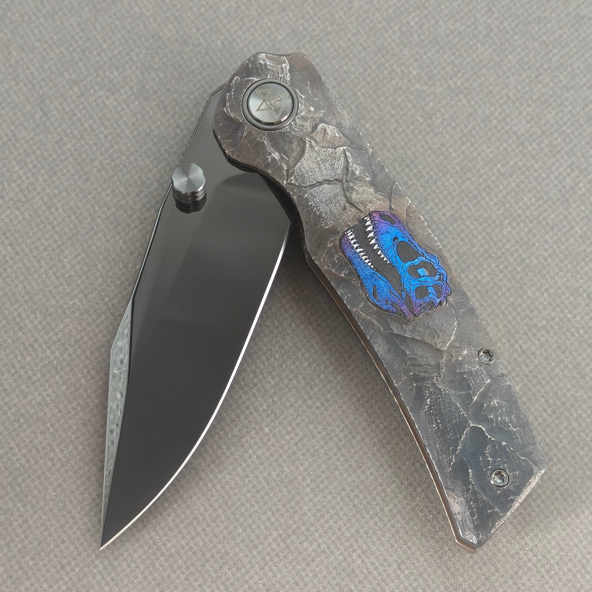VORIXN Rex KB118 Folding Knife – partially open EDC view showing flipper, thumb stud, pivot, and hand-engraved anodized titanium handle profile