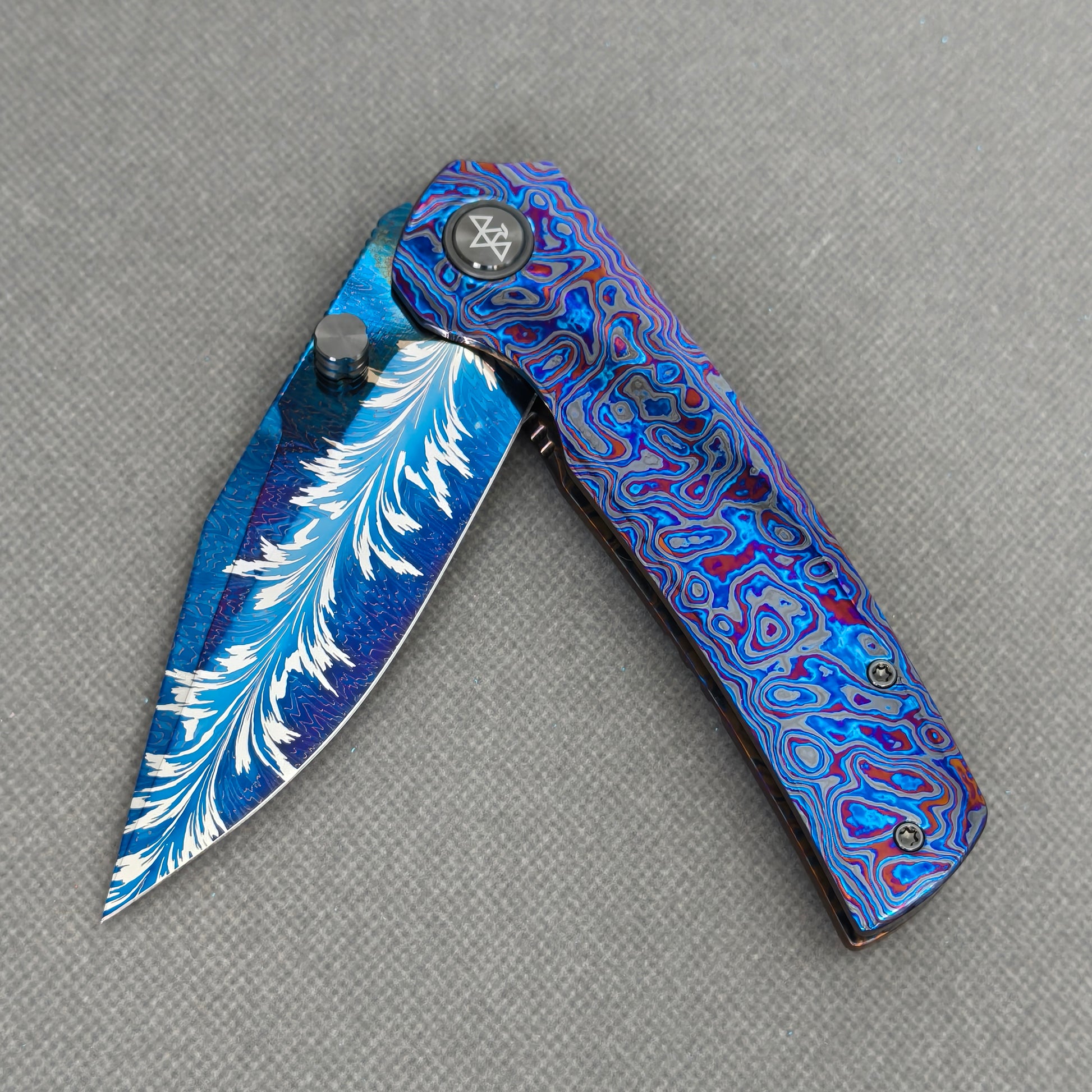 VORIXN KB082 Aurora Black Folding Knife – partially open EDC view showing flipper, thumb stud, pivot, and Zirconium handle profile