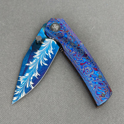 VORIXN KB082 Aurora Black Folding Knife – partially open EDC view showing flipper, thumb stud, pivot, and Zirconium handle profile