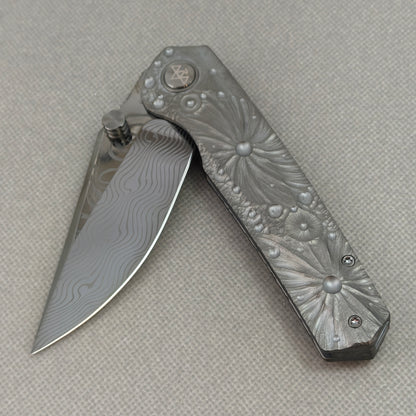 VORIXN KB098 Impact Origin Folding Knife – partially open EDC view showing flipper, thumb stud, pivot, and engraved Titanium handle profile