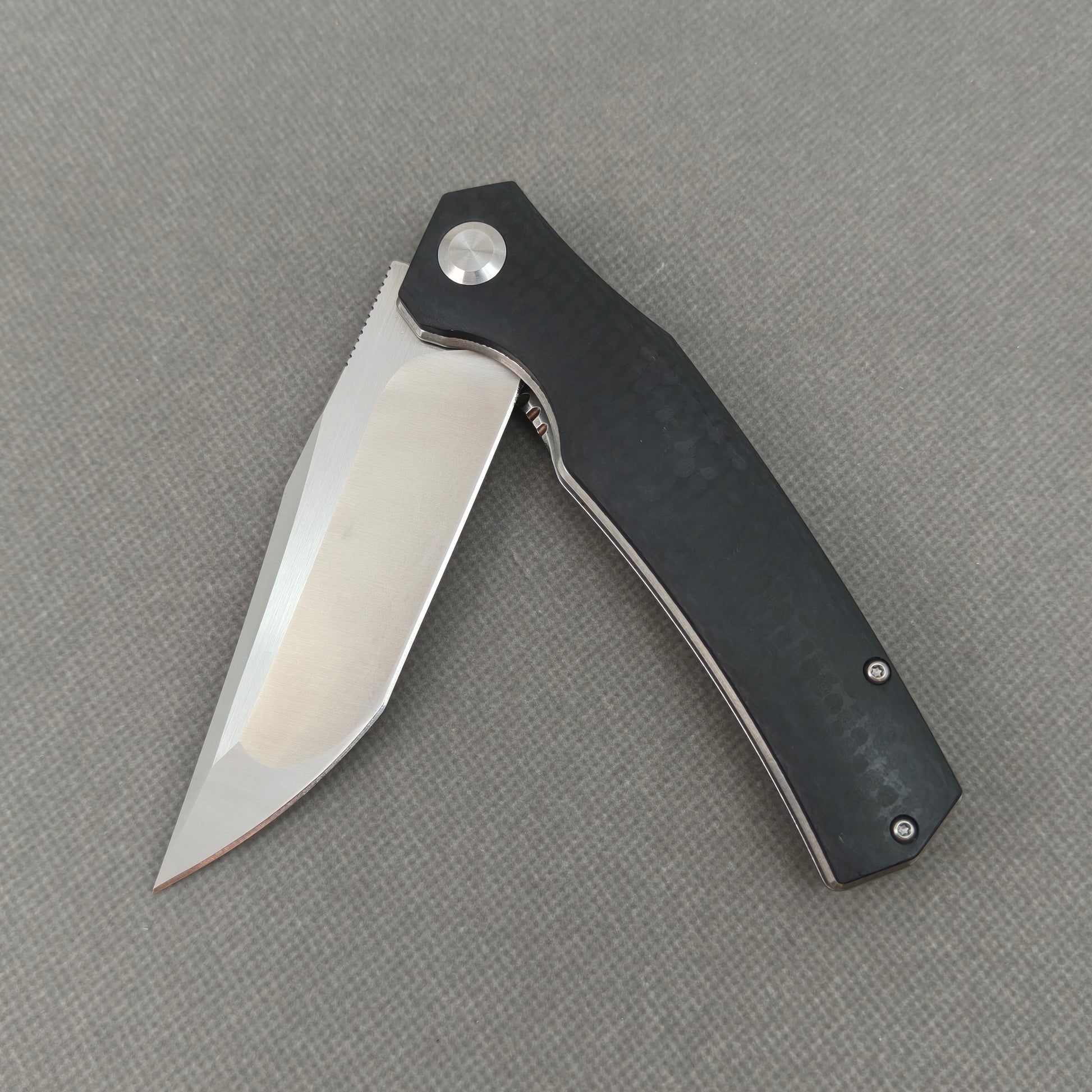 VORIXN KA006 partially open EDC folding knife showing flipper, pivot, and G10 handle profile.