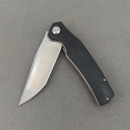 VORIXN KA006 partially open EDC folding knife showing flipper, pivot, and G10 handle profile.