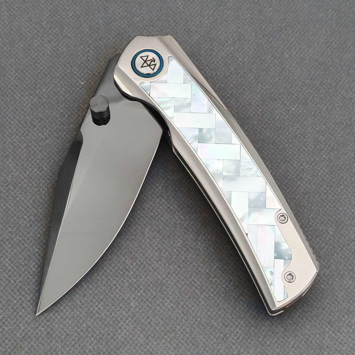 VORIXN Ocean Mirage KB093 with the blade partially open, showing the white patterned handle inlay and black thumb stud.