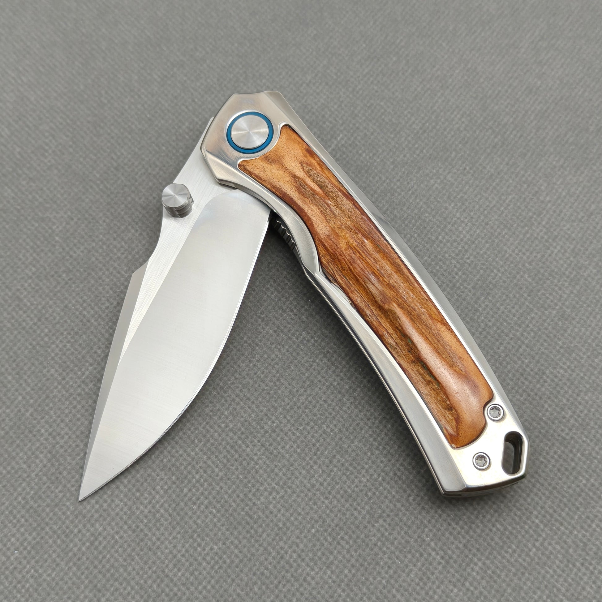VORIXN KB043 partially open EDC folding knife showing flipper, thumb stud, pivot, and natural stag inlay handle profile.