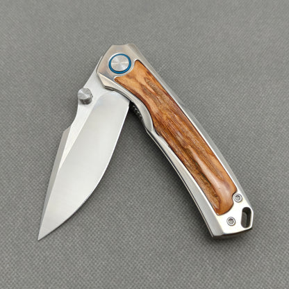 VORIXN KB043 partially open EDC folding knife showing flipper, thumb stud, pivot, and natural stag inlay handle profile.