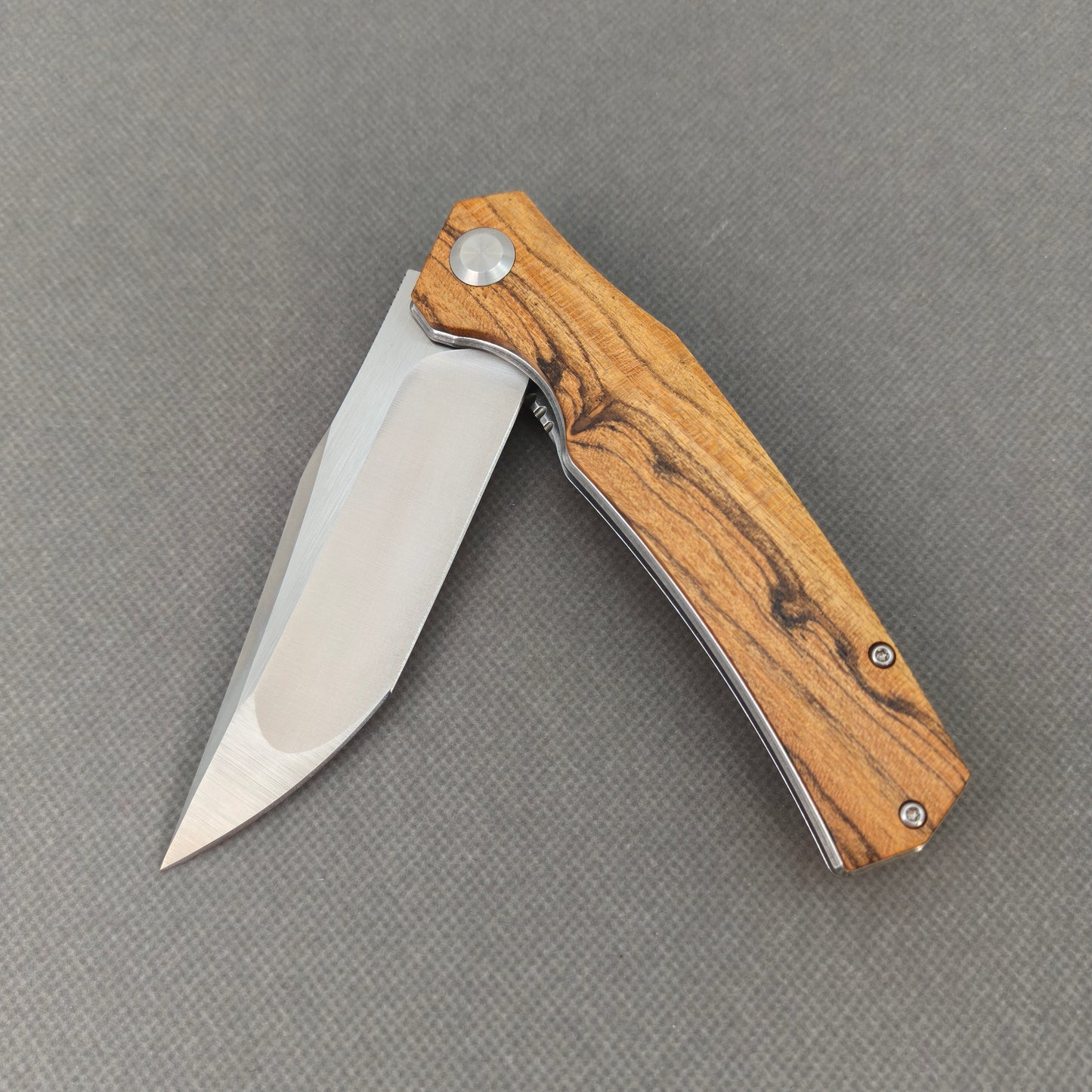 VORIXN KA013 partially open pocket knife showing flipper, pivot, and golden sandalwood handle profile.