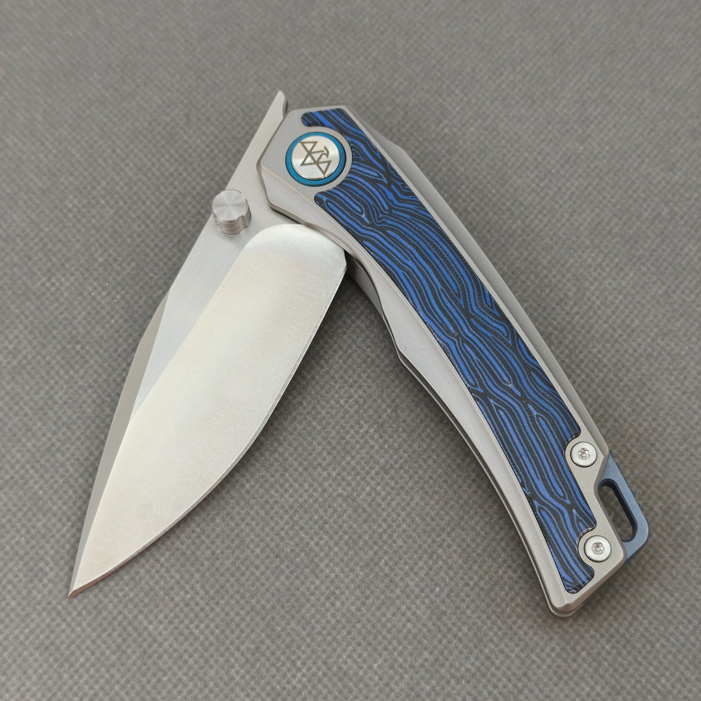 VORIXN KB005 partially open pocket knife showing flipper, thumb stud, ceramic bearing pivot, and handle profile.