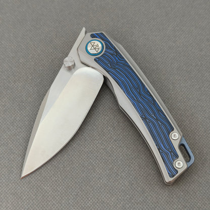 VORIXN KB005 partially open pocket knife showing flipper, thumb stud, ceramic bearing pivot, and handle profile.