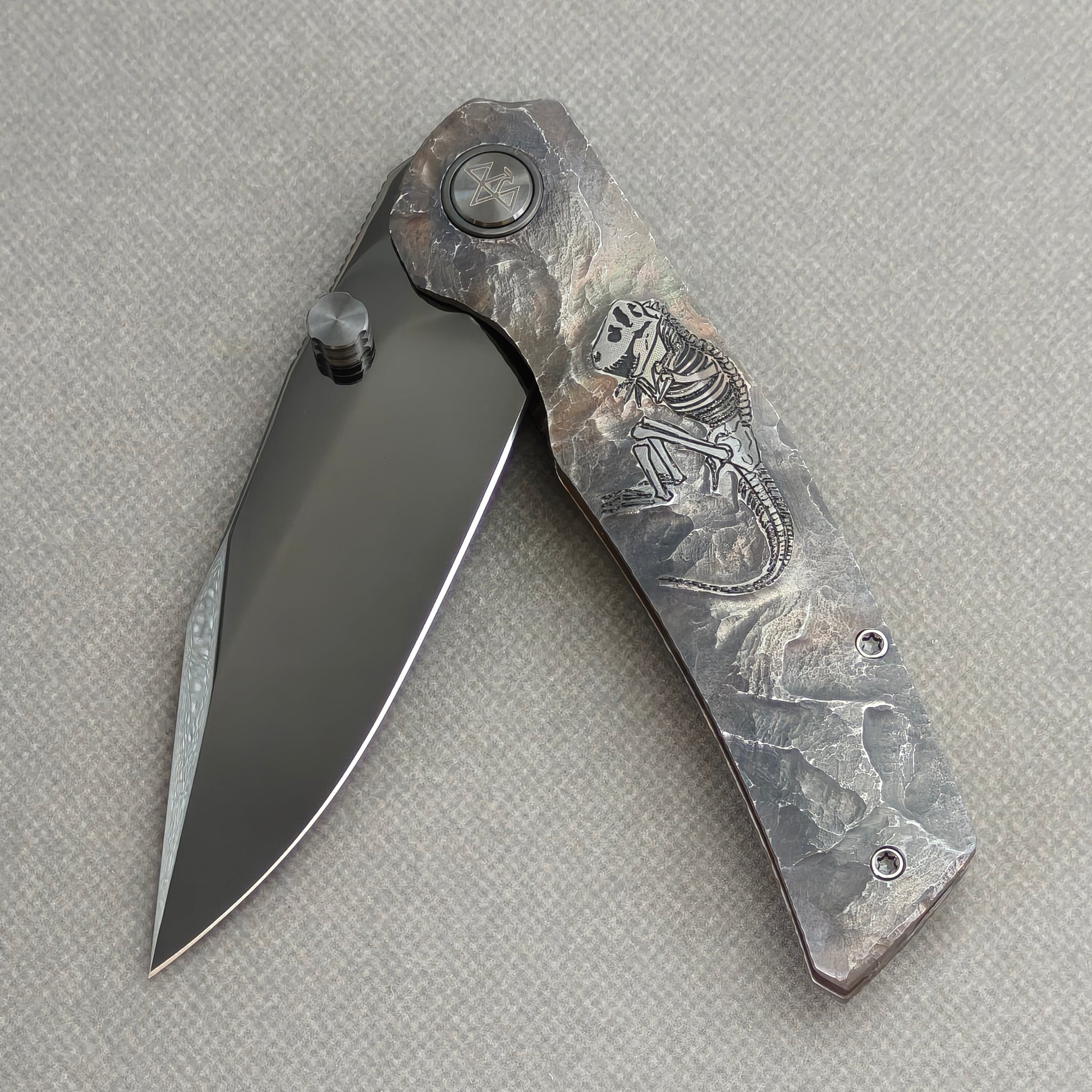 VORIXN Rex KB119 Folding Knife – partially open EDC view showing flipper, thumb stud, pivot, and hand-engraved titanium handle profile