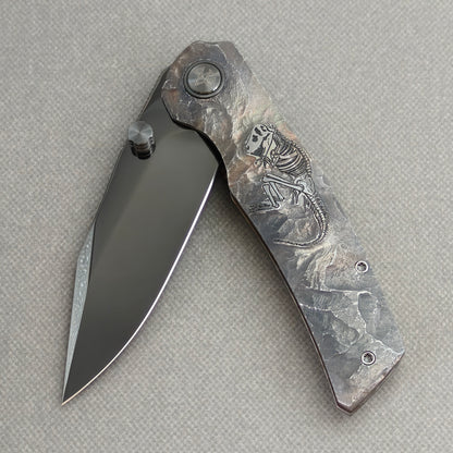 VORIXN Rex KB119 Folding Knife – partially open EDC view showing flipper, thumb stud, pivot, and hand-engraved titanium handle profile