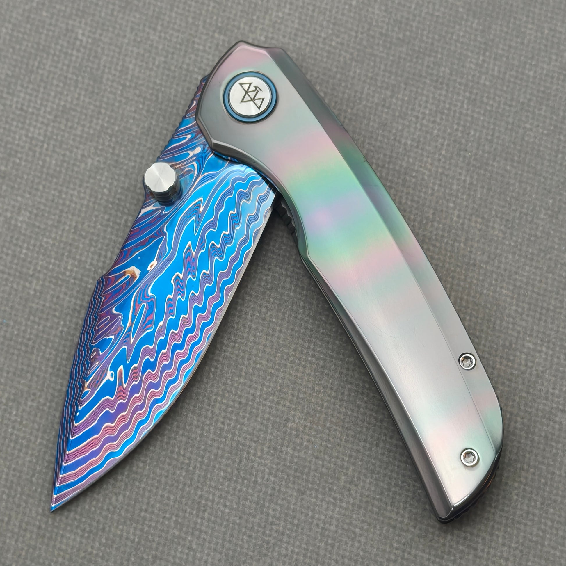 VORIXN Spectra KB127 Folding Knife – partially open EDC view showing flipper, thumb stud, pivot, and zirconium handle profile