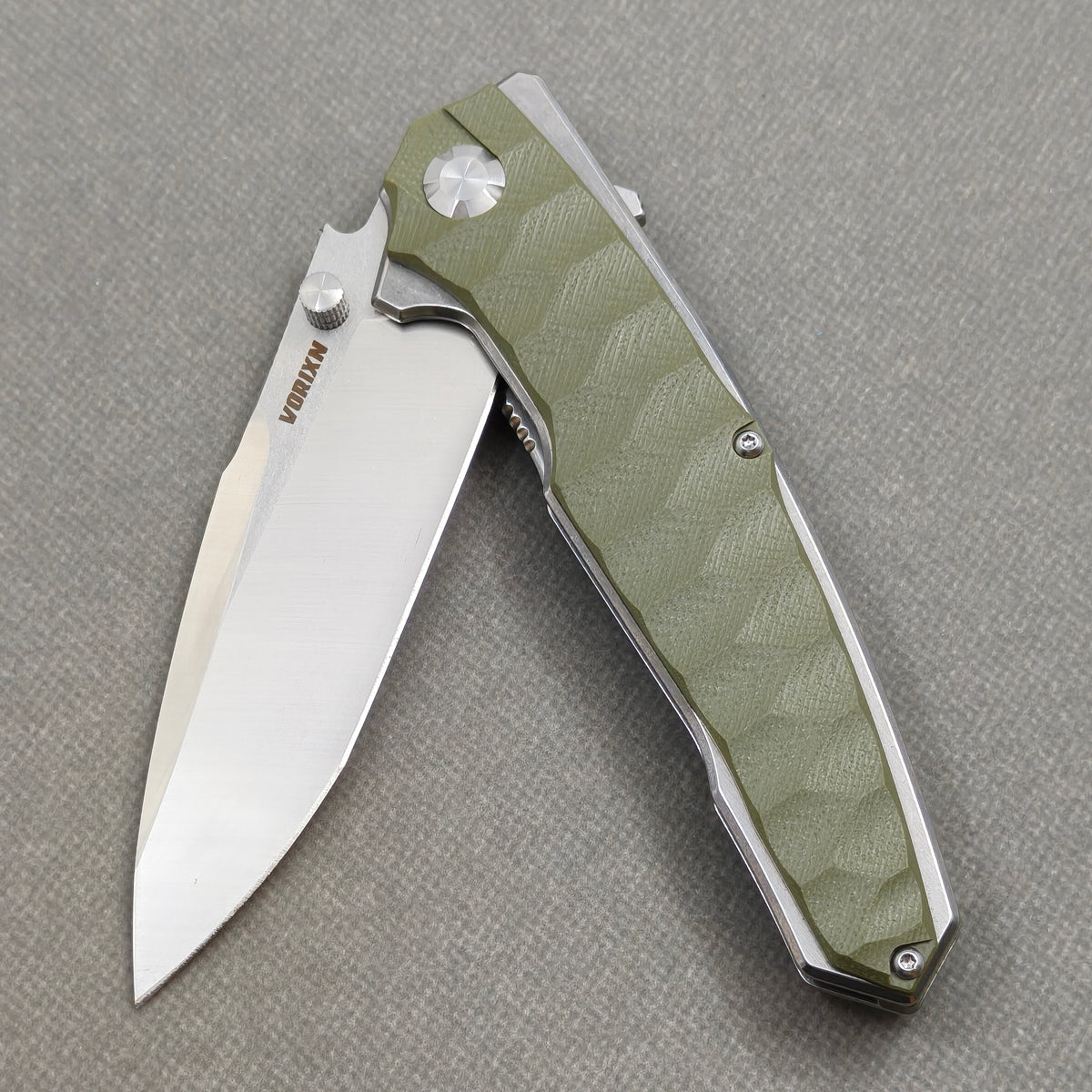 VORIXN KA007 Folding Knife – partially open EDC view showing flipper, thumb stud, pivot, and Stainless Steel & G10 handle profile
