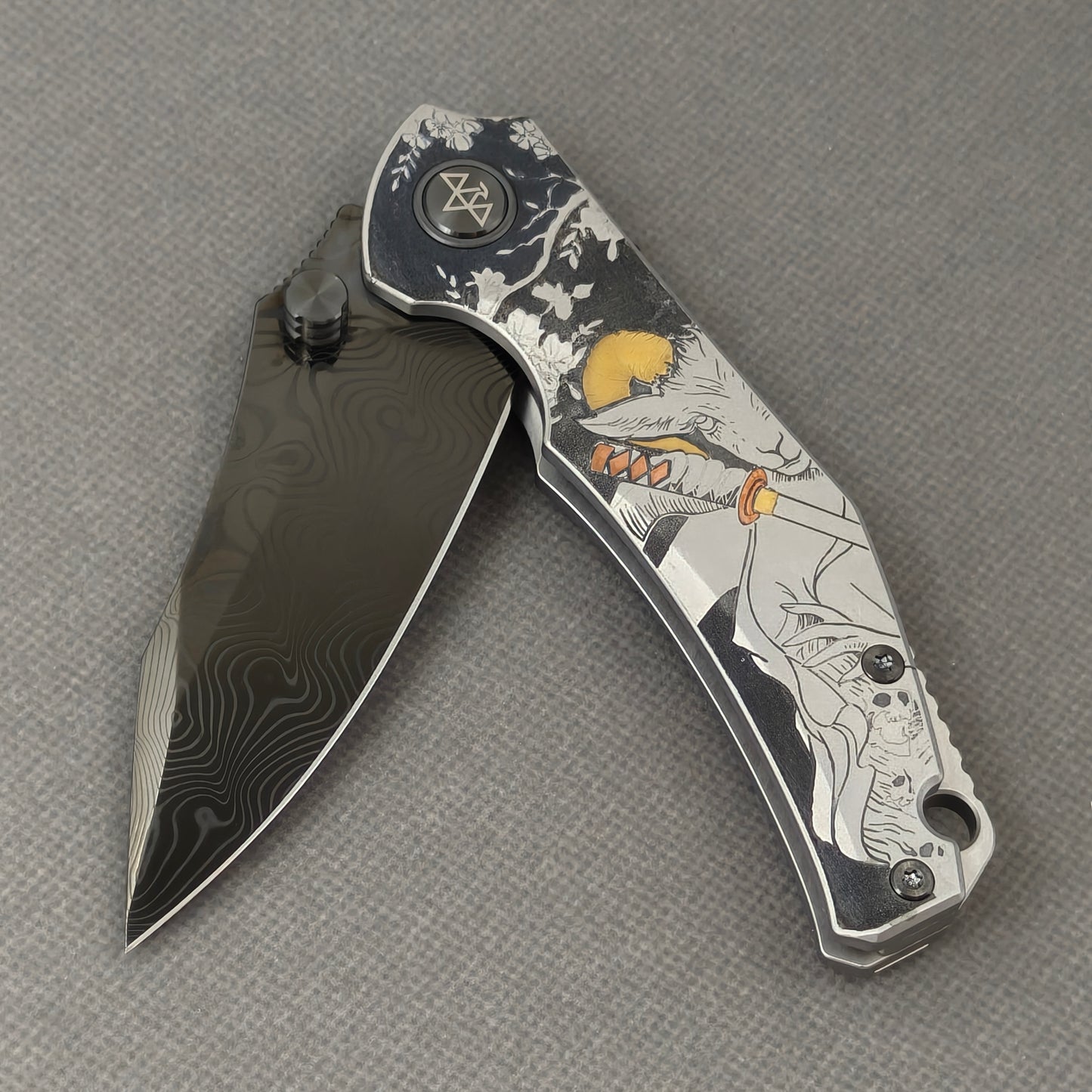 VORIXN Yokai KB106 Folding Knife – partially open EDC view showing flipper, thumb stud, pivot, and Laser-Engraved Copper Accents Titanium handle profile