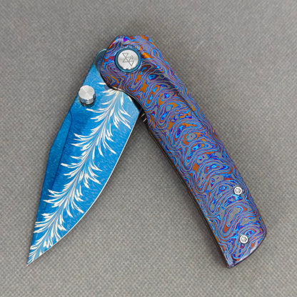 VORIXN KB081 Aurora Bright Folding Knife – partially open EDC view showing flipper, thumb stud, pivot, and Zirconium handle profile