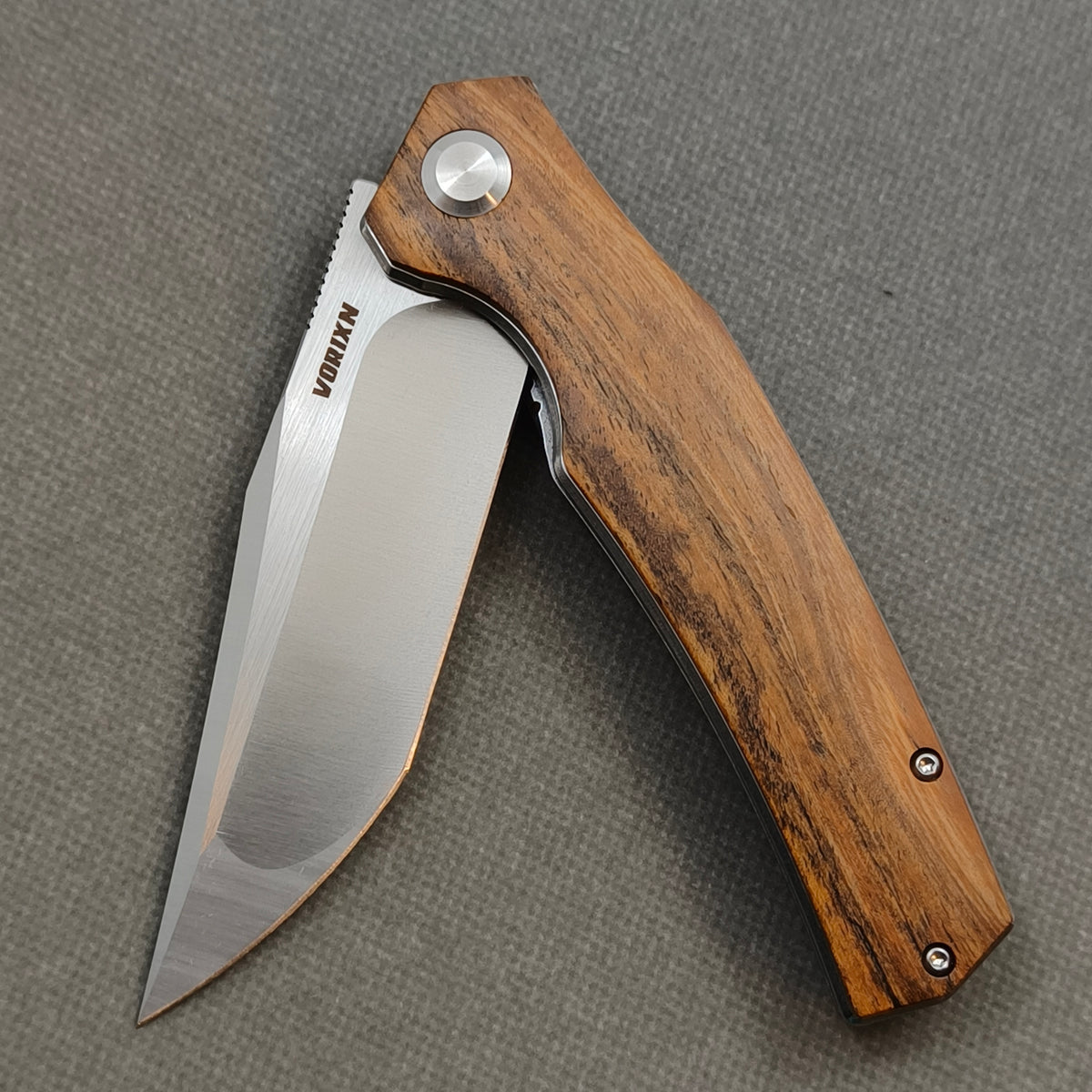 VORIXN KA013 Folding Knife – partially open EDC view showing flipper, thumb stud, pivot, and Golden Sandalwood handle profile
