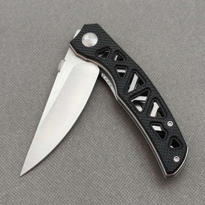 VORIXN KA003 partially open EDC folding knife showing flipper, thumb stud, pivot, and G10 handle profile.