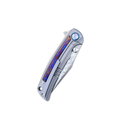 VORIXN Nebula knife closed, clip side view with titanium frame, pocket clip, and colorful zirconium inlay design.