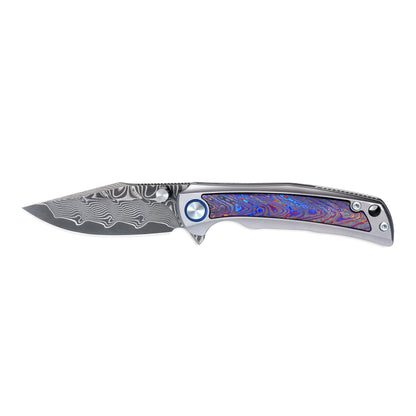 VORIXN Nebula folding knife open, side view highlighting the Damascus blade pattern and titanium zirconium inlay handle.