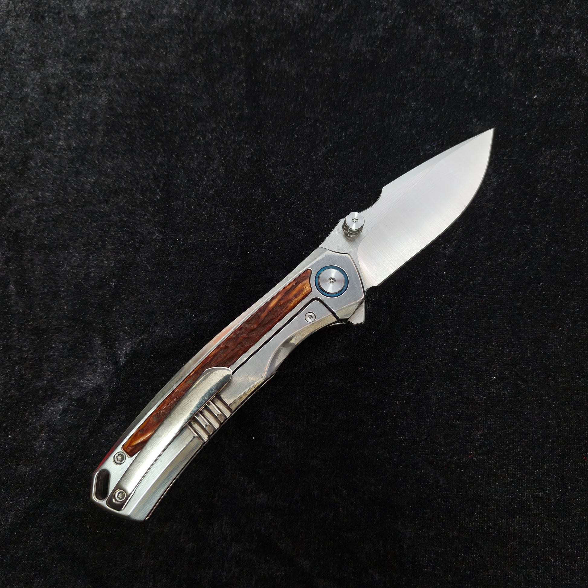 VORIXN AURON folding knife open, pocket clip side, VG10 blade angled upward with titanium handle