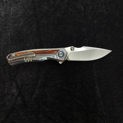 VORIXN AURON folding knife open horizontally, titanium handle with natural stag inlay detail, clip side
