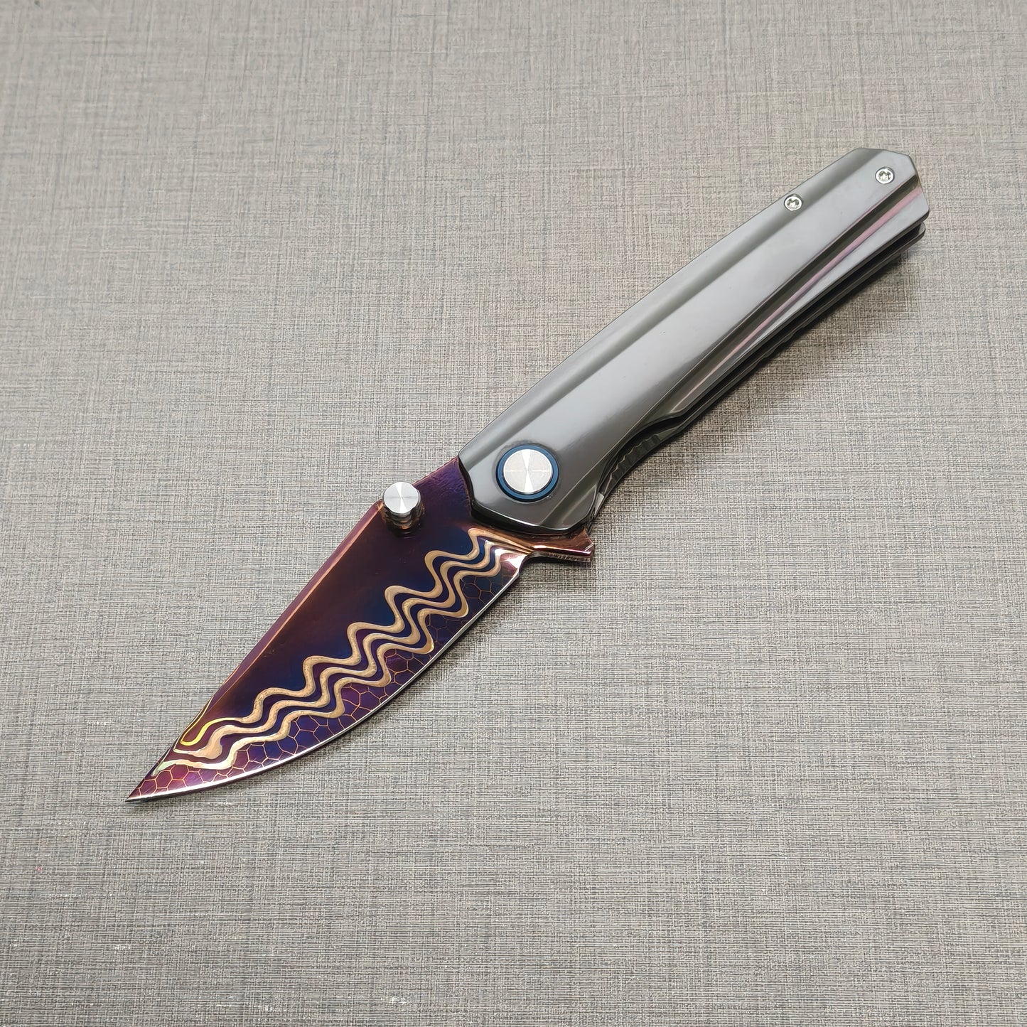 VORIXN Pyretic folding knife open, non-clip side view with blade angled downward, Damascus steel blade