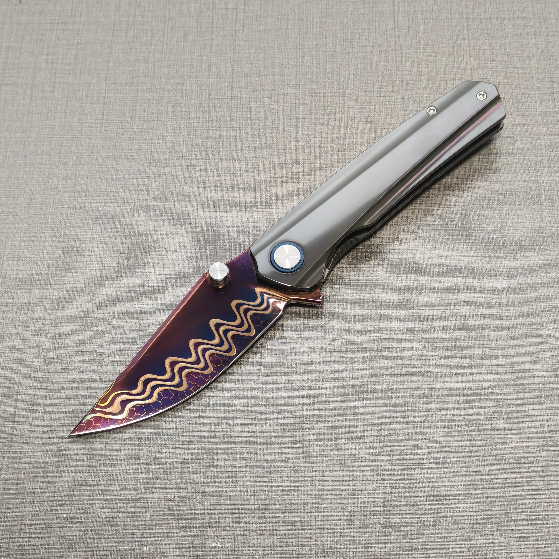 VORIXN Pyretic folding knife open, non-clip side view with blade angled downward, Damascus steel blade