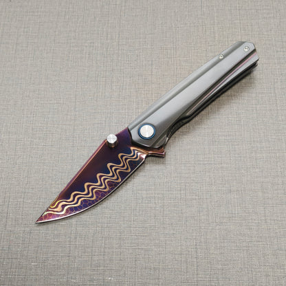 VORIXN Pyretic folding knife open, non-clip side view with blade angled downward, Damascus steel blade