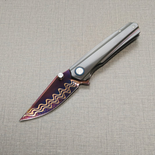 VORIXN Pyretic folding knife open, non-clip side view with blade angled downward, Damascus steel blade