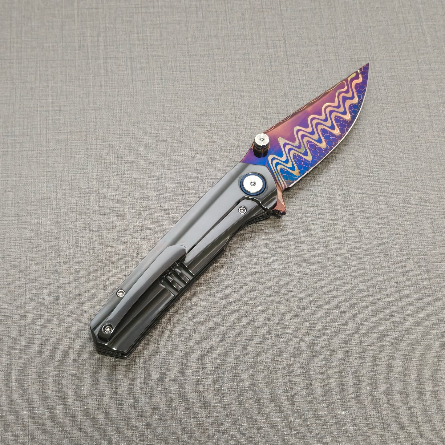 VORIXN Pyretic folding knife open, pocket clip side view with blade angled upward, zirconium handle