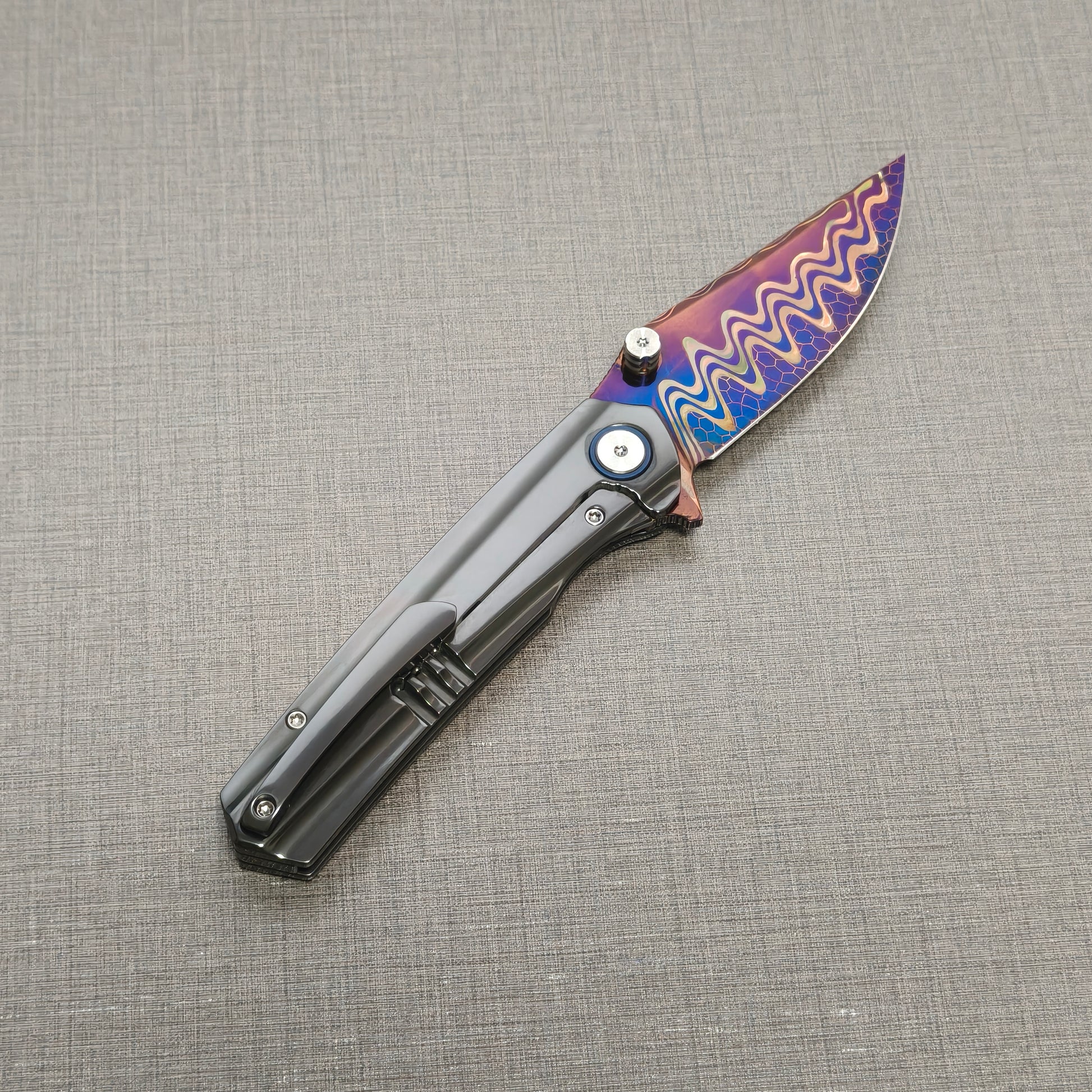 VORIXN Pyretic folding knife open, pocket clip side view with blade angled upward, zirconium handle