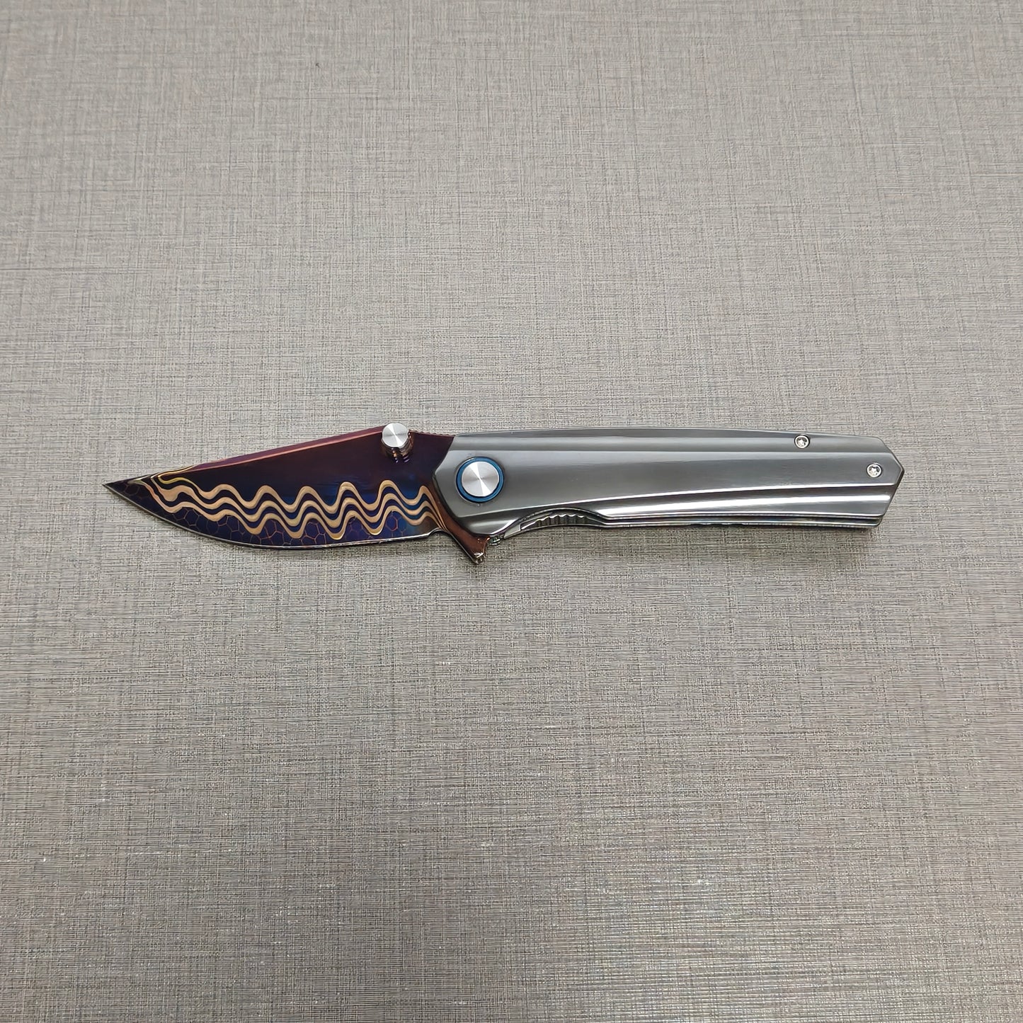 VORIXN Pyretic folding knife open, non-clip side with blade held horizontally, zirconium handle