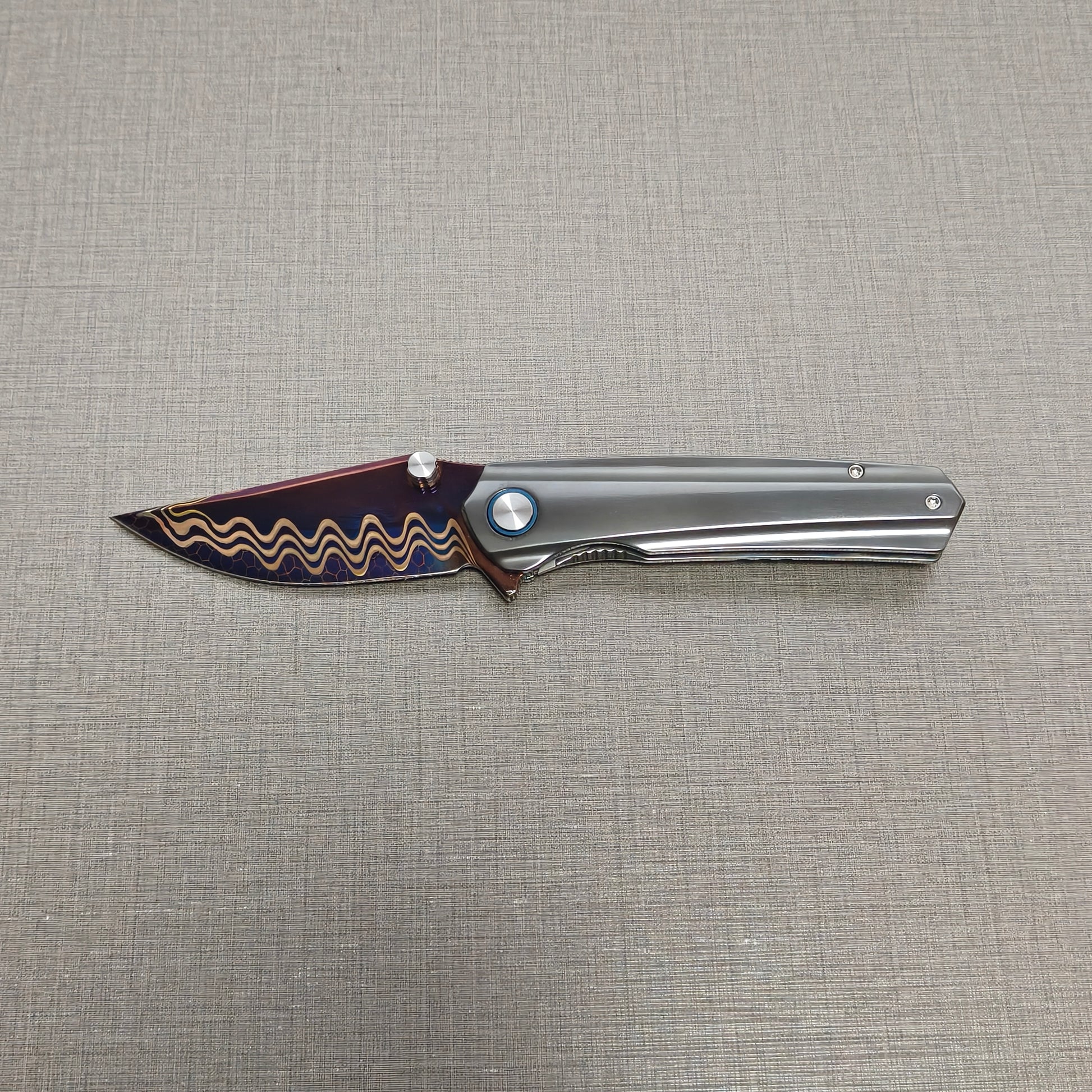 VORIXN Pyretic folding knife open, non-clip side with blade held horizontally, zirconium handle