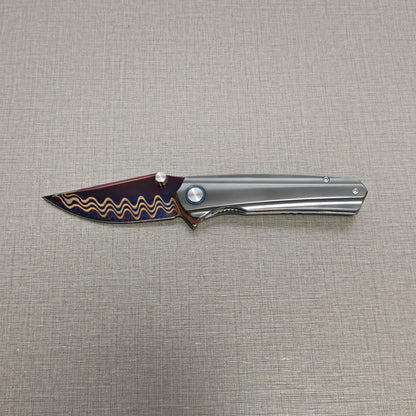 VORIXN Pyretic folding knife open, non-clip side with blade held horizontally, zirconium handle