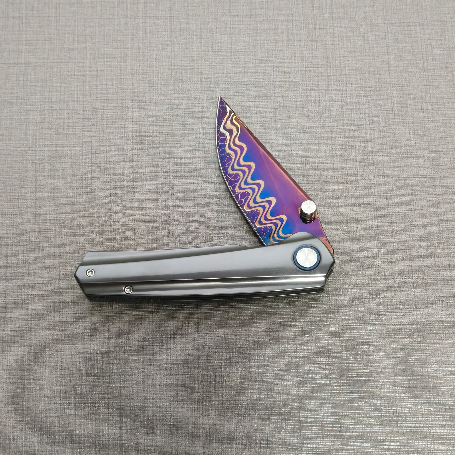 VORIXN Pyretic folding knife partially open, non-clip side view highlighting handle proportions