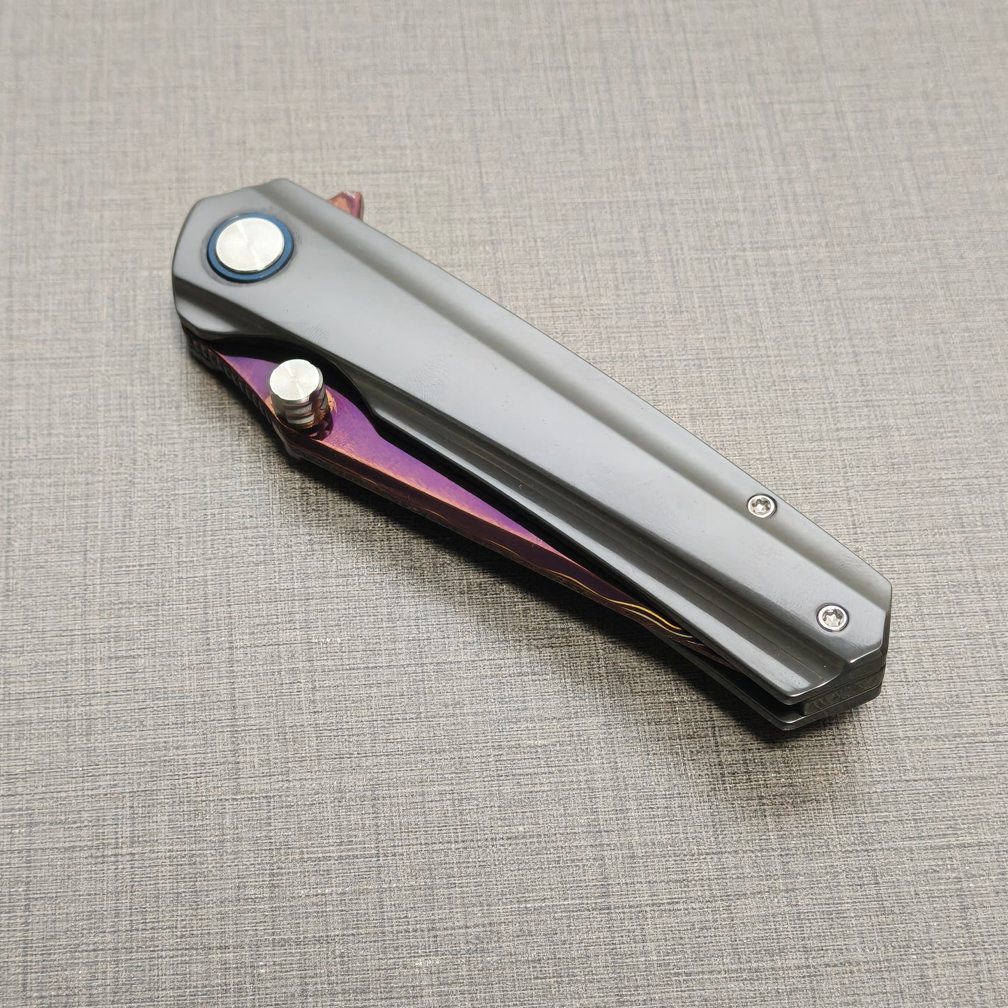 VORIXN Pyretic folding knife closed, non-clip side highlighting zirconium handle texture and pattern