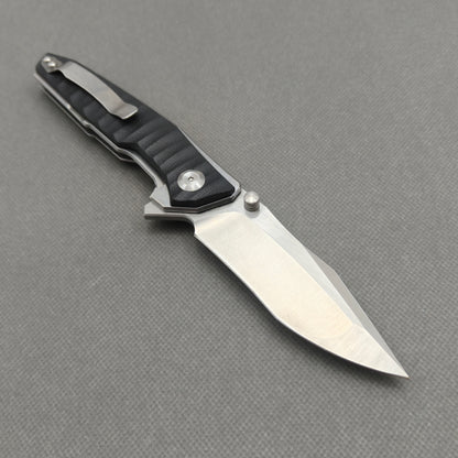 VORIXN KA008 open clip-side view showing pocket clip, black G10 handle structure, and overall profile.