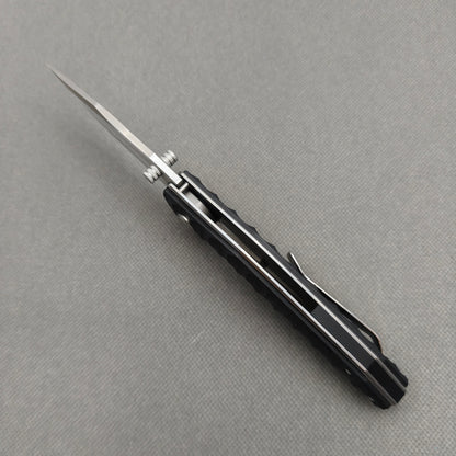 VORIXN KA008 closed non-clip side view showing black G10 handle design and pivot detail.